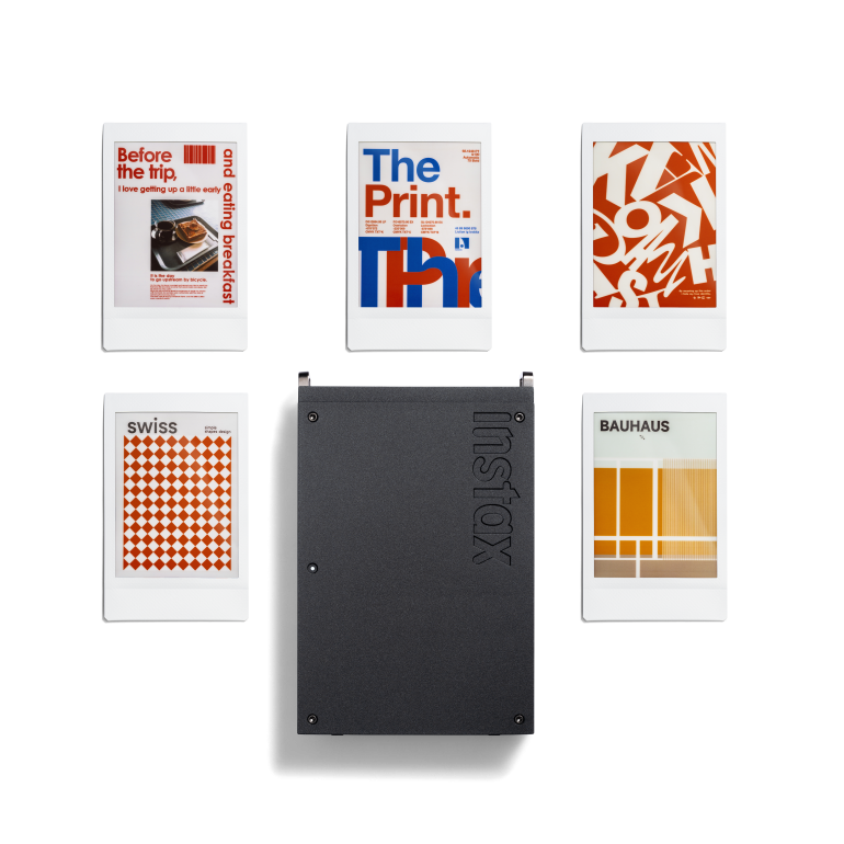 Five Instax photos with graphic designs and a black Instax photo album arranged on a white background.