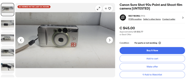 A silver Canon Sure Shot 90u point and shoot film camera on display against a white background.